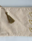 Trousse beige en velours côtelé avec 3 cœurs dorés